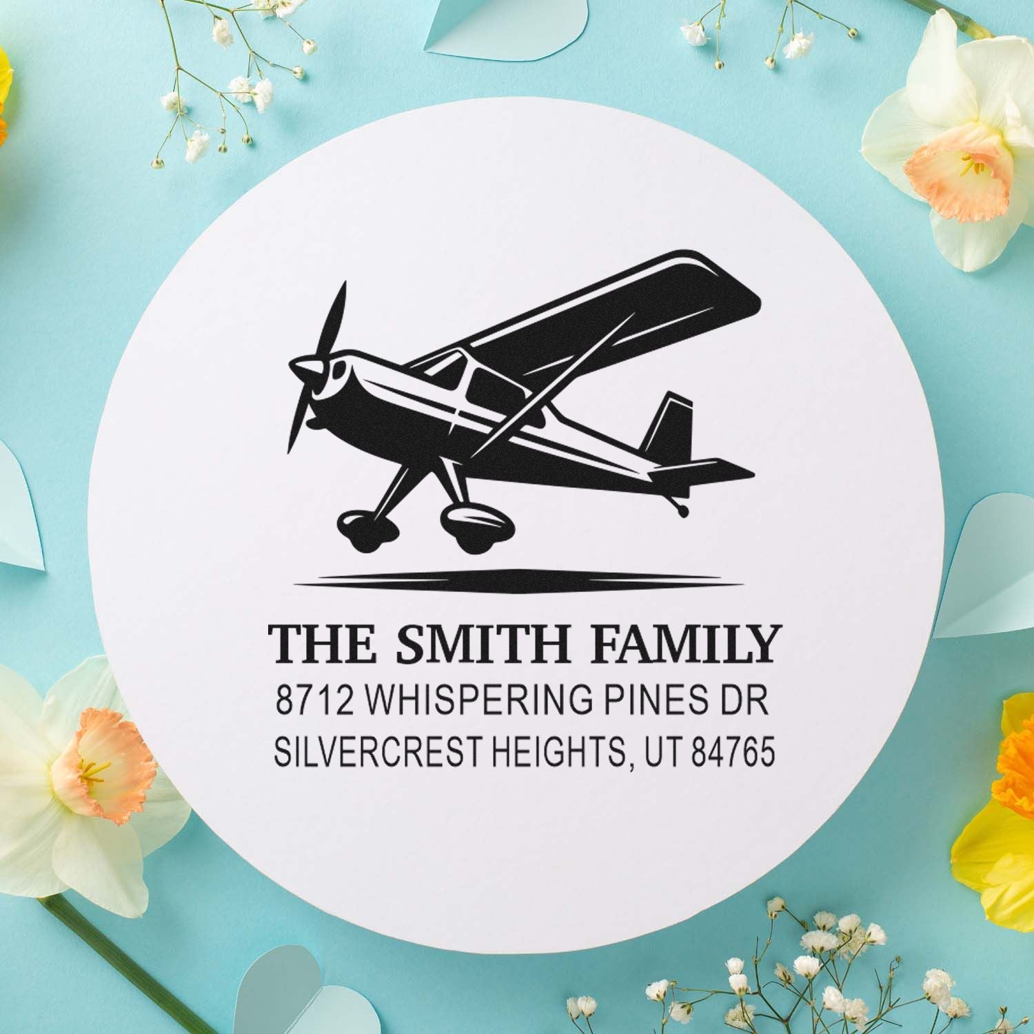 Custom airplane return address stamp for The Smith Family with Utah address, displayed on a pastel floral background.