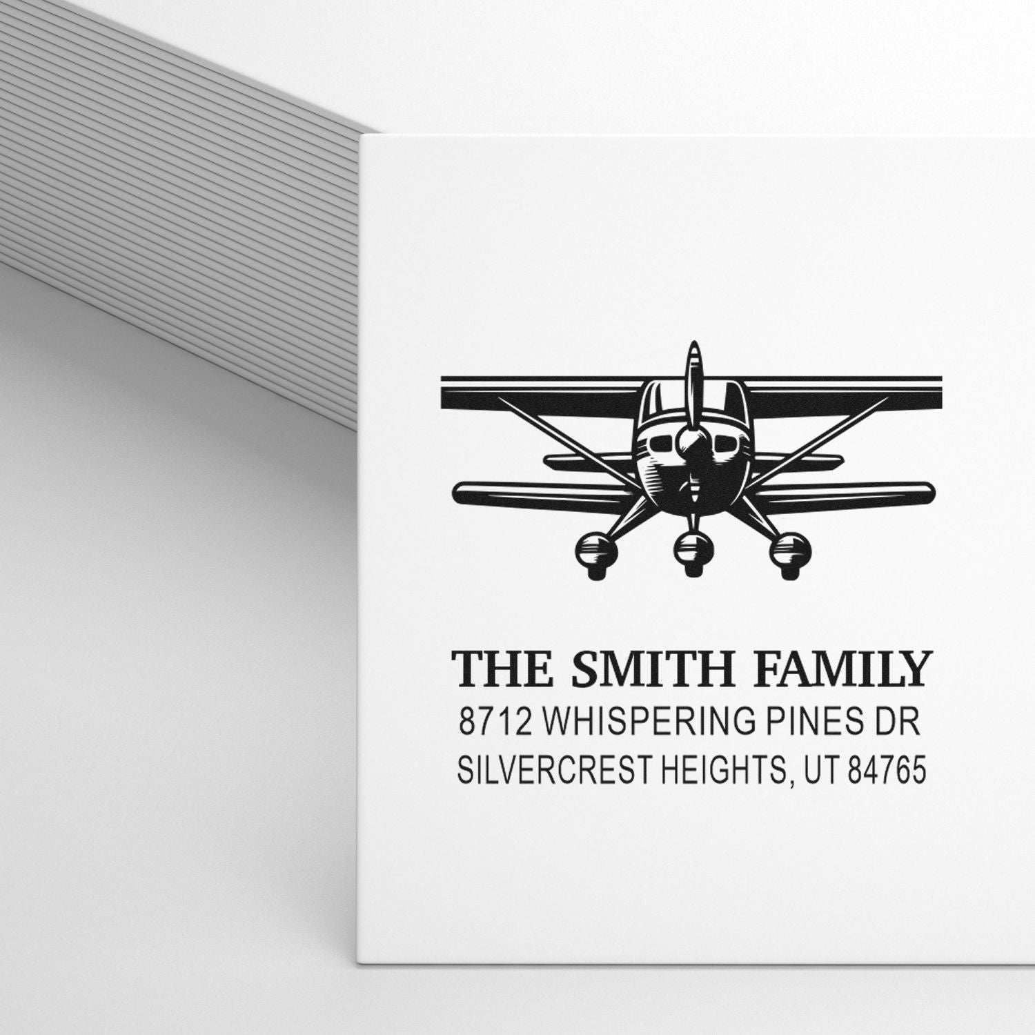 Custom airplane address rubber stamp featuring The Smith Family name, Whispering Pines Dr, and Silvercrest Heights, UT return address for mail.