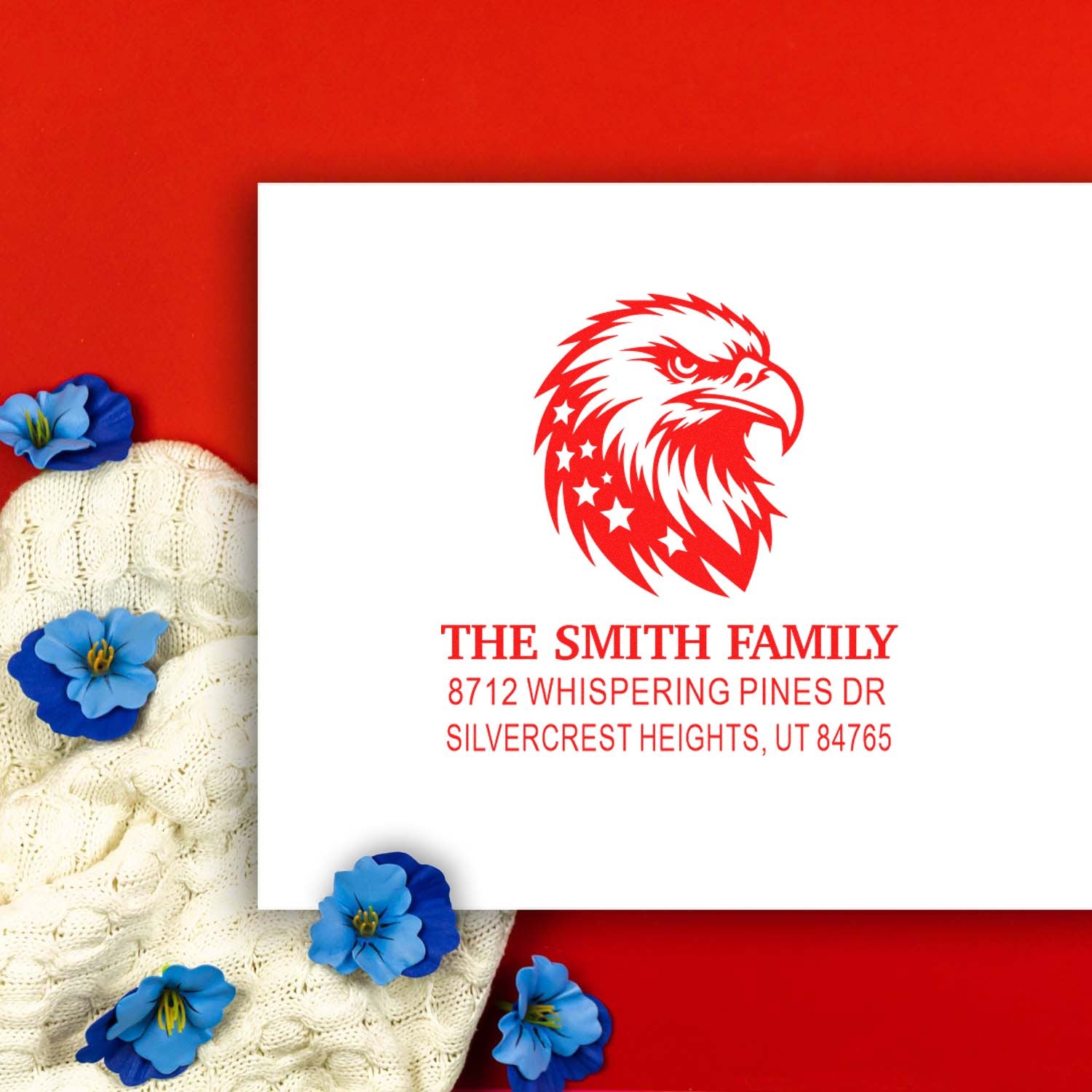 Personalized eagle address stamp with The Smith Family name and Utah address, styled on a red background with blue flowers and knit fabric.