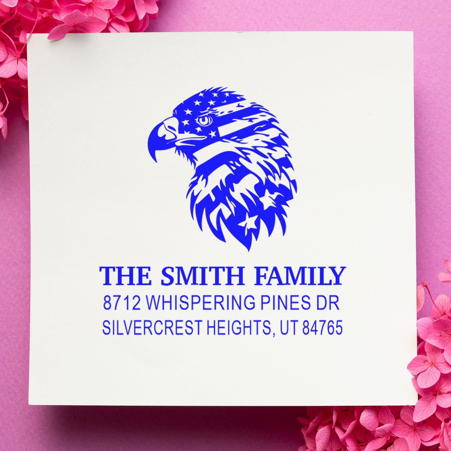 Custom return address stamp with blue eagle logo and The Smith Family address on a pink floral background.