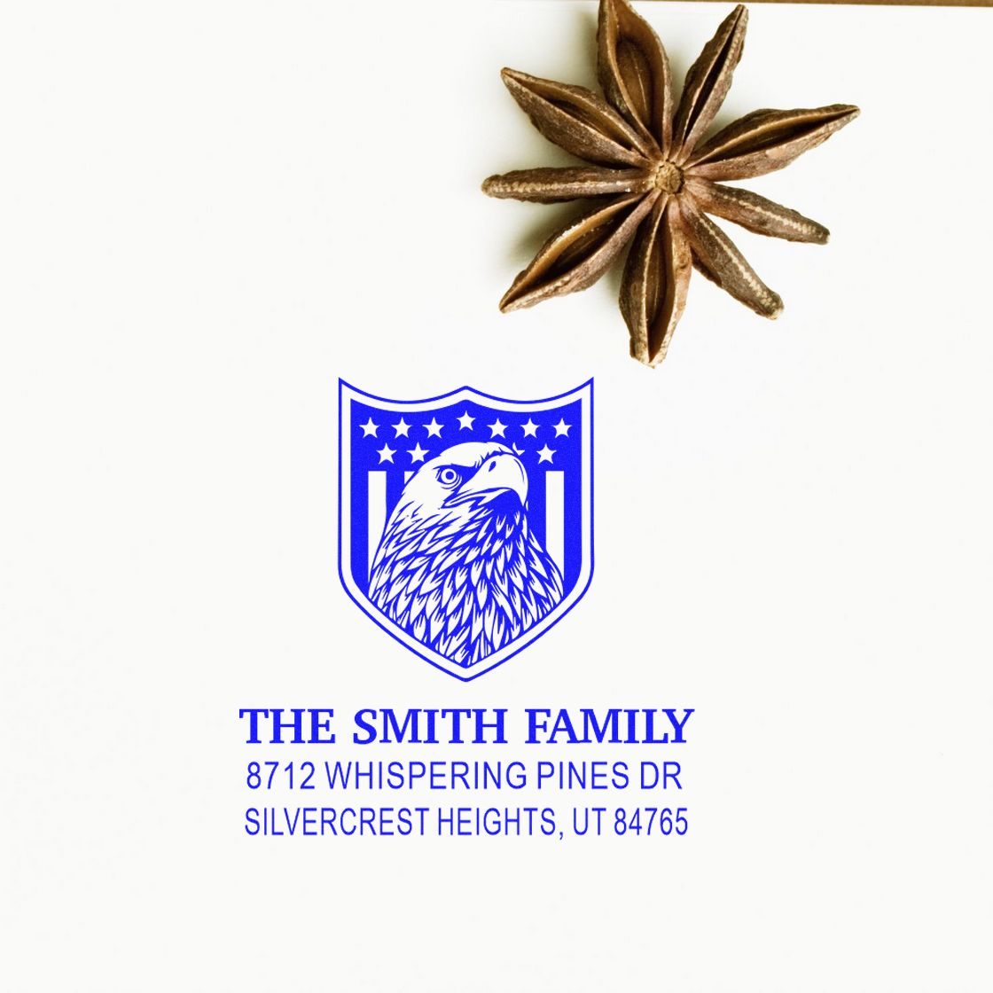 Custom personalized rubber address stamp with eagle shield emblem, star border, and Smith family name and address in blue ink for mailing.