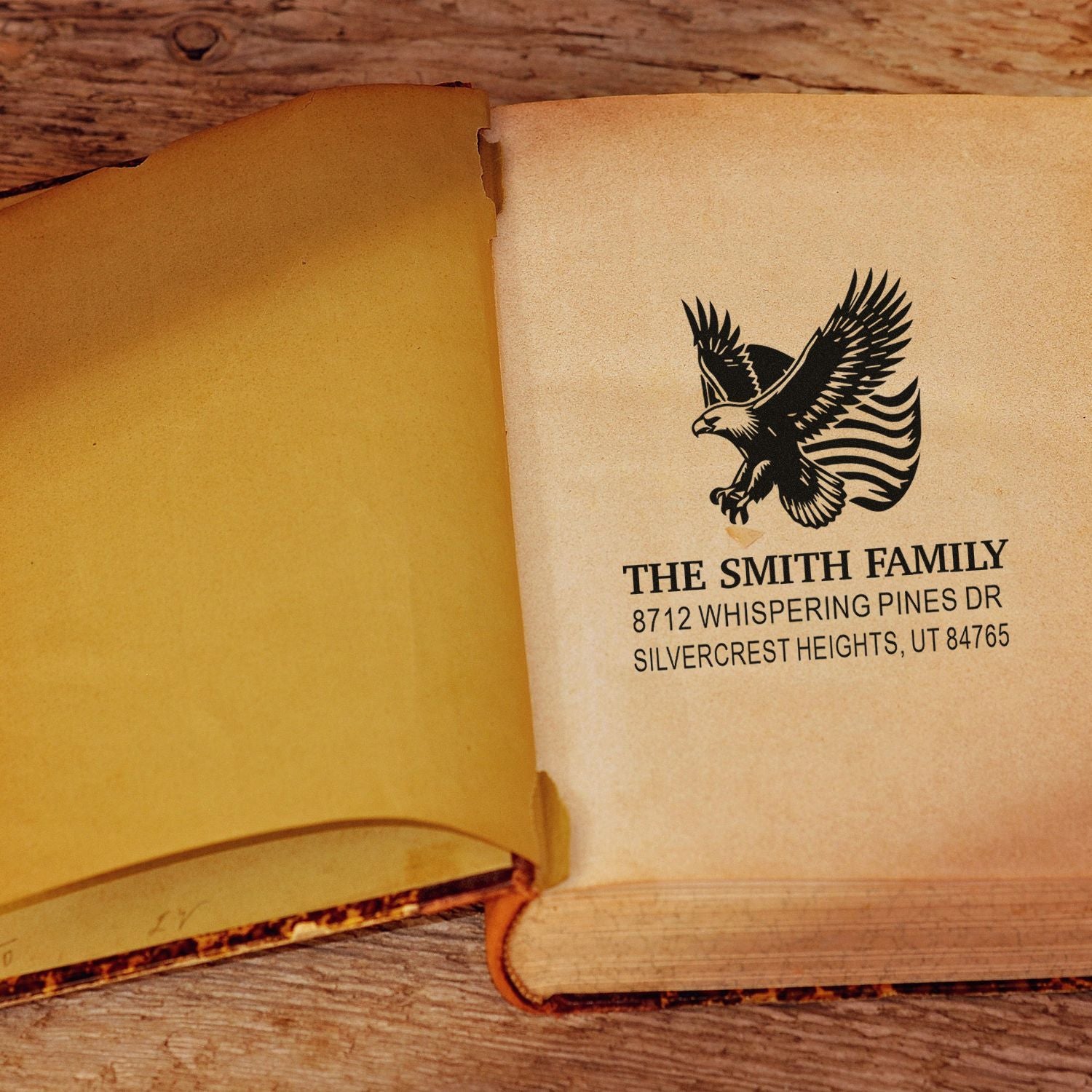 Personalized family address rubber stamp with eagle design, featuring The Smith Family name and custom address on a vintage book page for correspondence