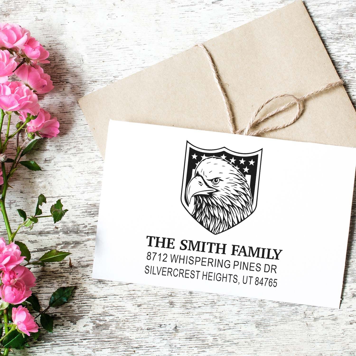 Custom return address rubber stamp with eagle shield design, family name and address on envelope for personalized mail, wedding, business, or home use.