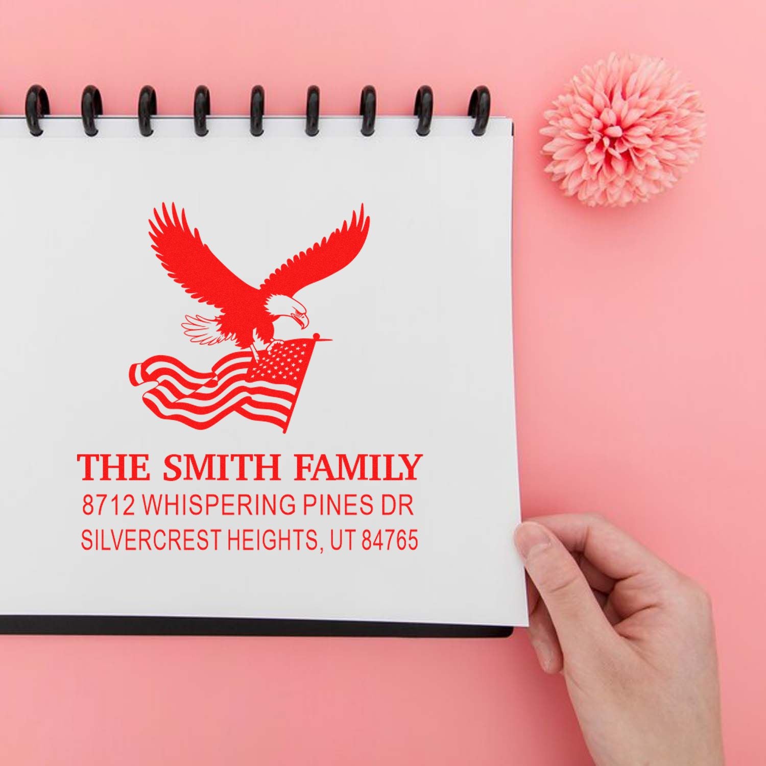 Custom address rubber stamp with eagle and American flag design, personalized The Smith Family name and mailing address on notebook paper.
