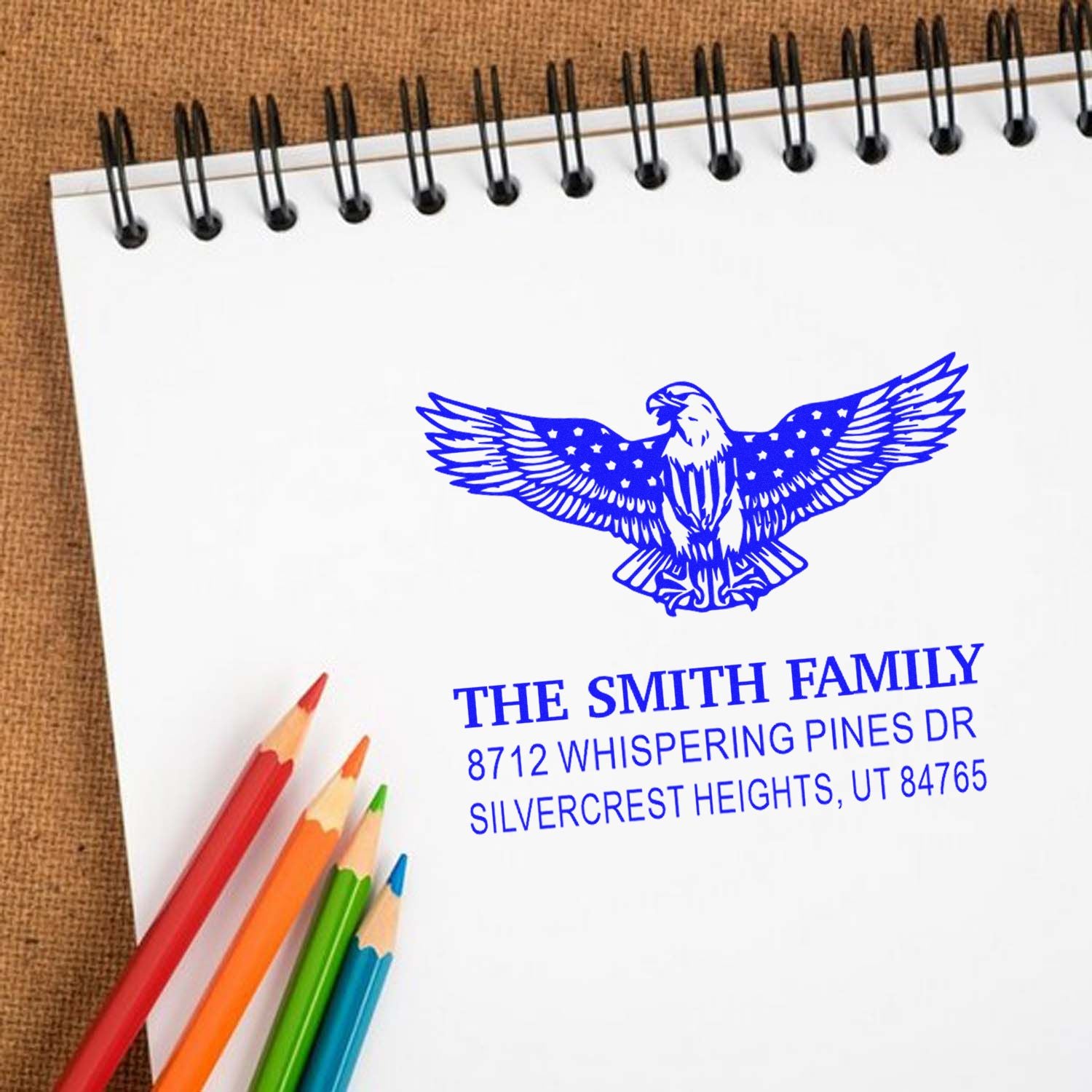 Custom family address rubber stamp with patriotic eagle design and blue ink impression, ideal for personalized mail, stationery, and cards.