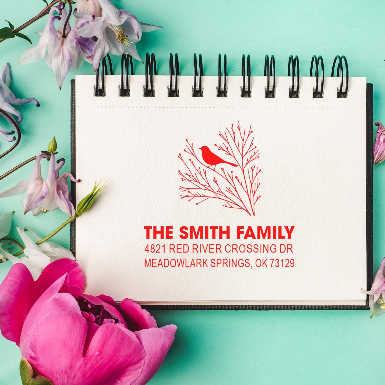 Custom return address rubber stamp with bird on branch design, featuring The Smith Family and Meadowlark Springs, OK address in red for envelopes.