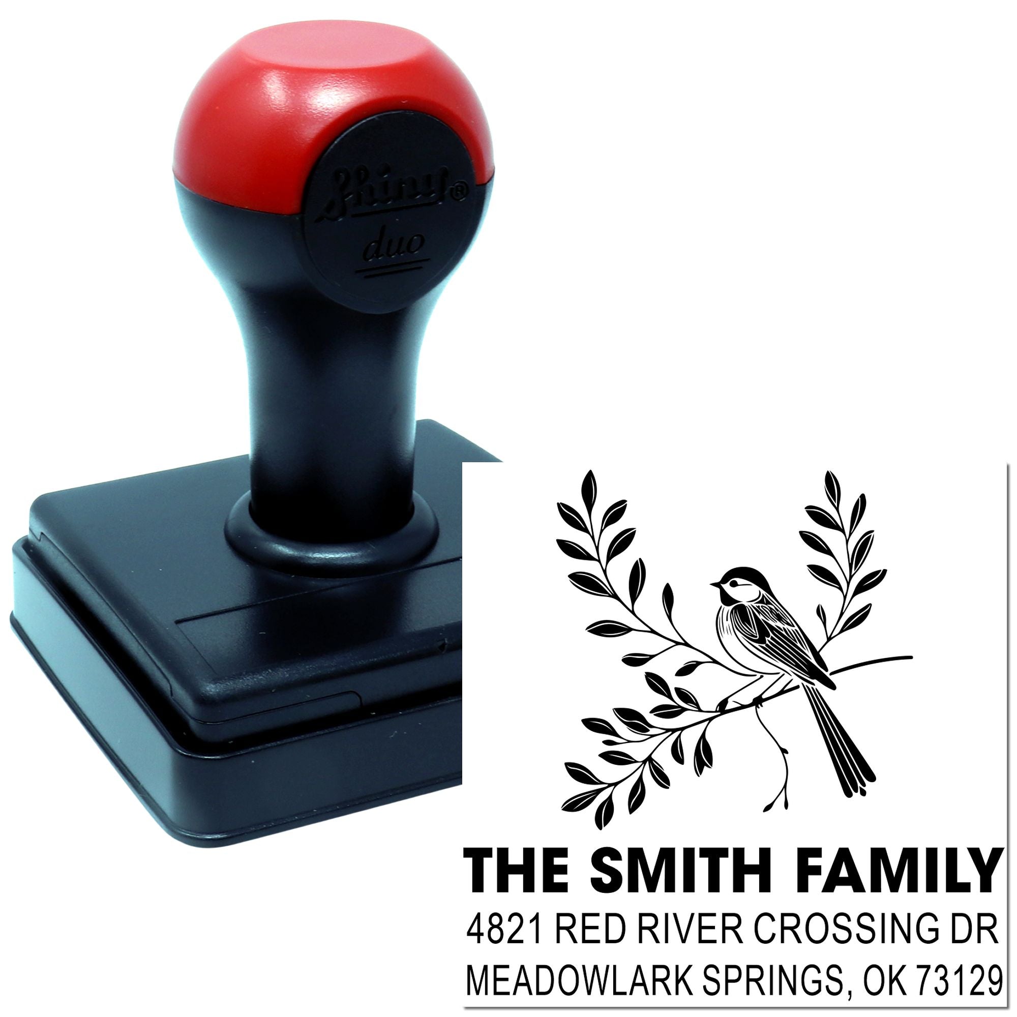 Custom self-inking rubber address stamp with red and black handle, featuring bird and branch design and The Smith Family return address.