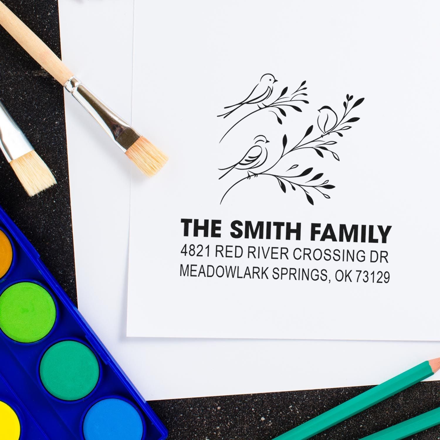 Custom return address rubber stamp with bird and branch design, featuring The Smith Family name and Meadowlark Springs, OK address for stationery