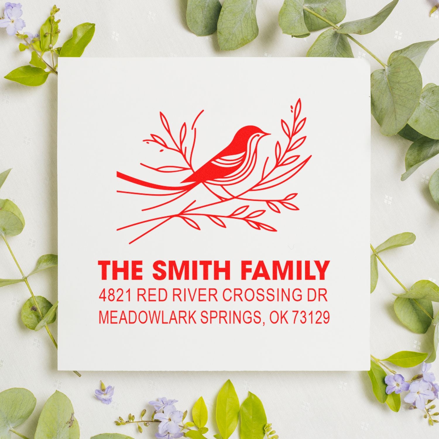Custom rubber address stamp featuring a red bird and botanical branch design with The Smith Family name and Meadowlark Springs, OK address
