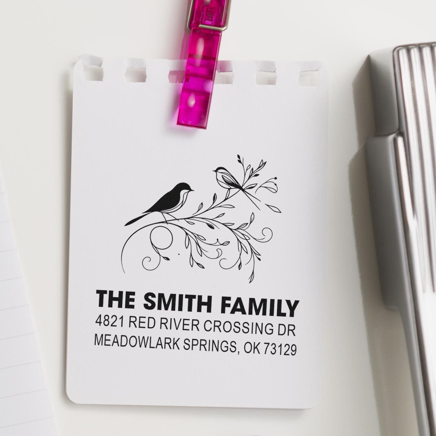 Custom return address rubber stamp with bird and floral design, featuring The Smith Family name and address on white paper for mailing use