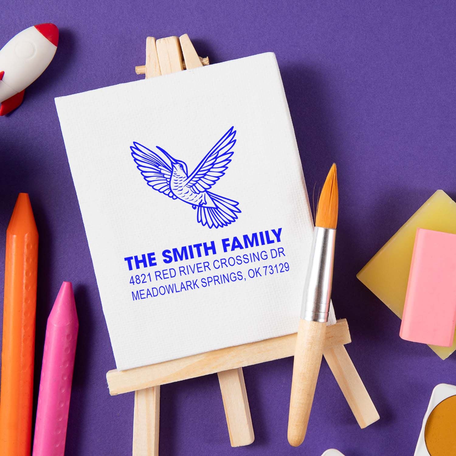 Custom return address rubber stamp with hummingbird design, The Smith Family name, and Meadowlark Springs, OK address on a canvas block
