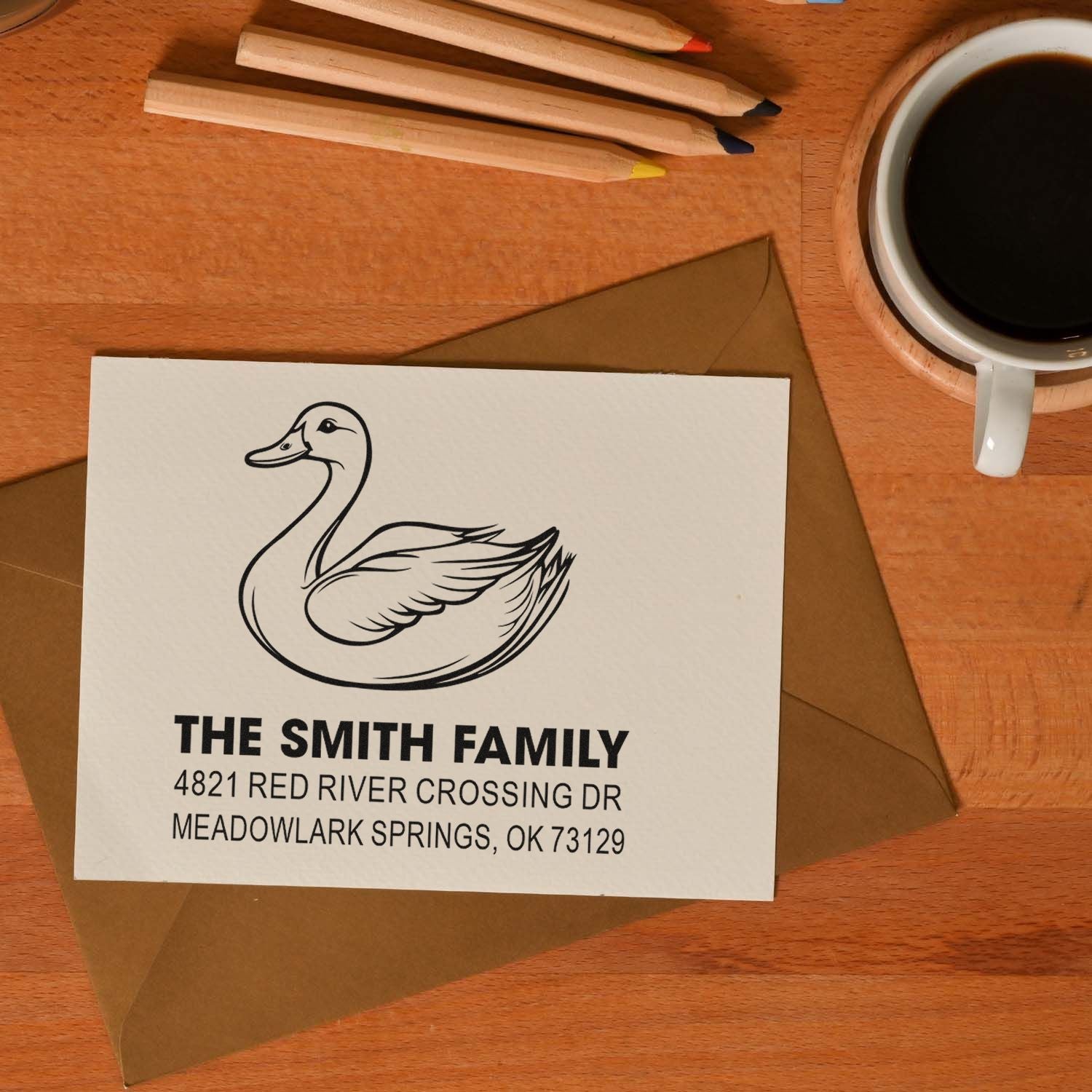 Custom rubber stamp return address design with duck logo, The Smith Family name, and mailing address on white card over kraft envelope for envelopes