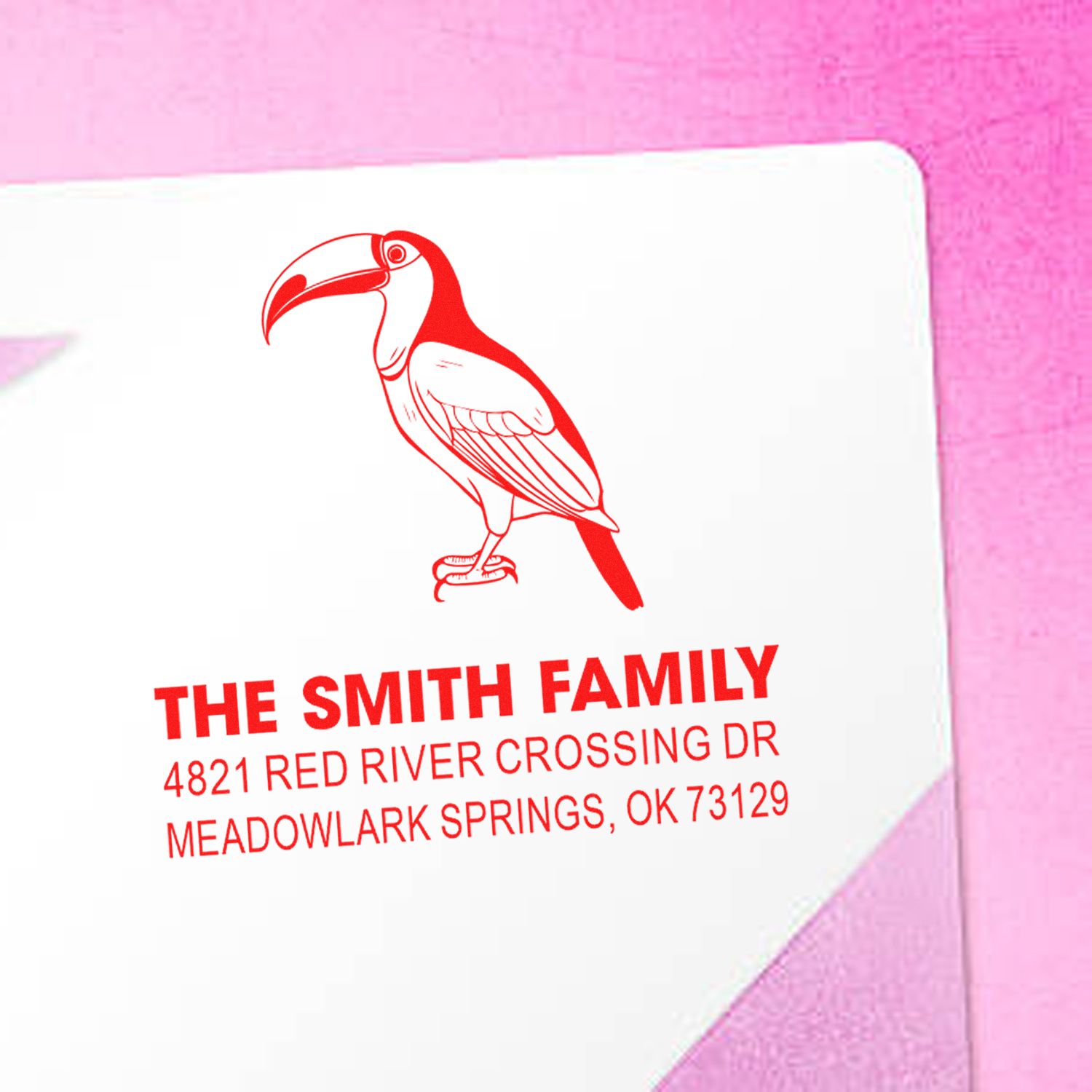 Custom red rubber address stamp with toucan design, Smith Family name, and Meadowlark Springs OK return address for envelopes and mailings.