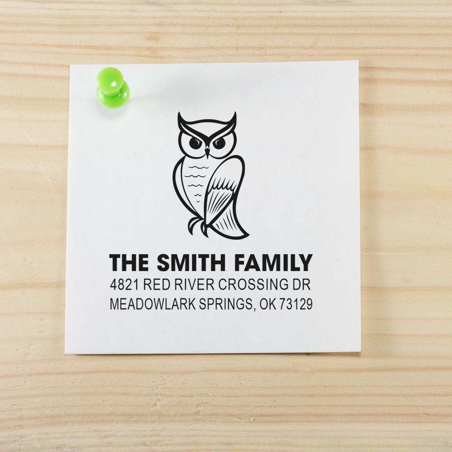 Custom owl return address rubber stamp for The Smith Family, featuring bold name and Meadowlark Springs, OK address on a white card pinned to wood.