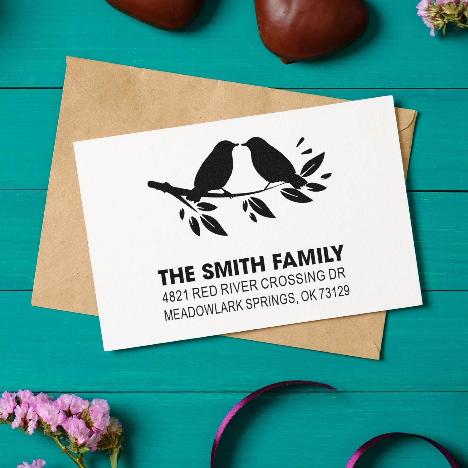 Custom return address rubber stamp with two birds on a branch, personalized family name and address for envelopes and wedding stationery.