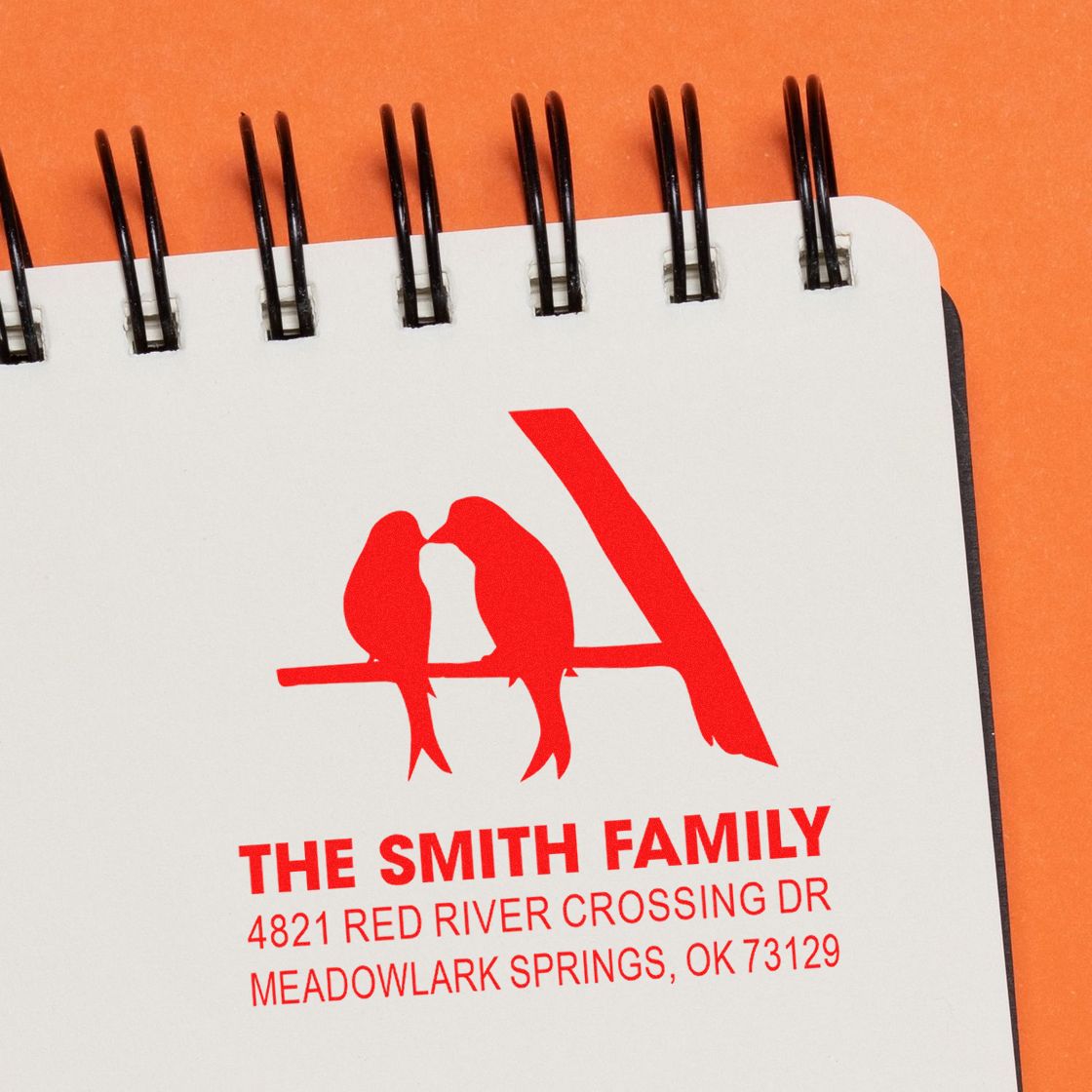 Custom rubber stamp return address design with birds, featuring The Smith Family name and address on a notebook-style card.