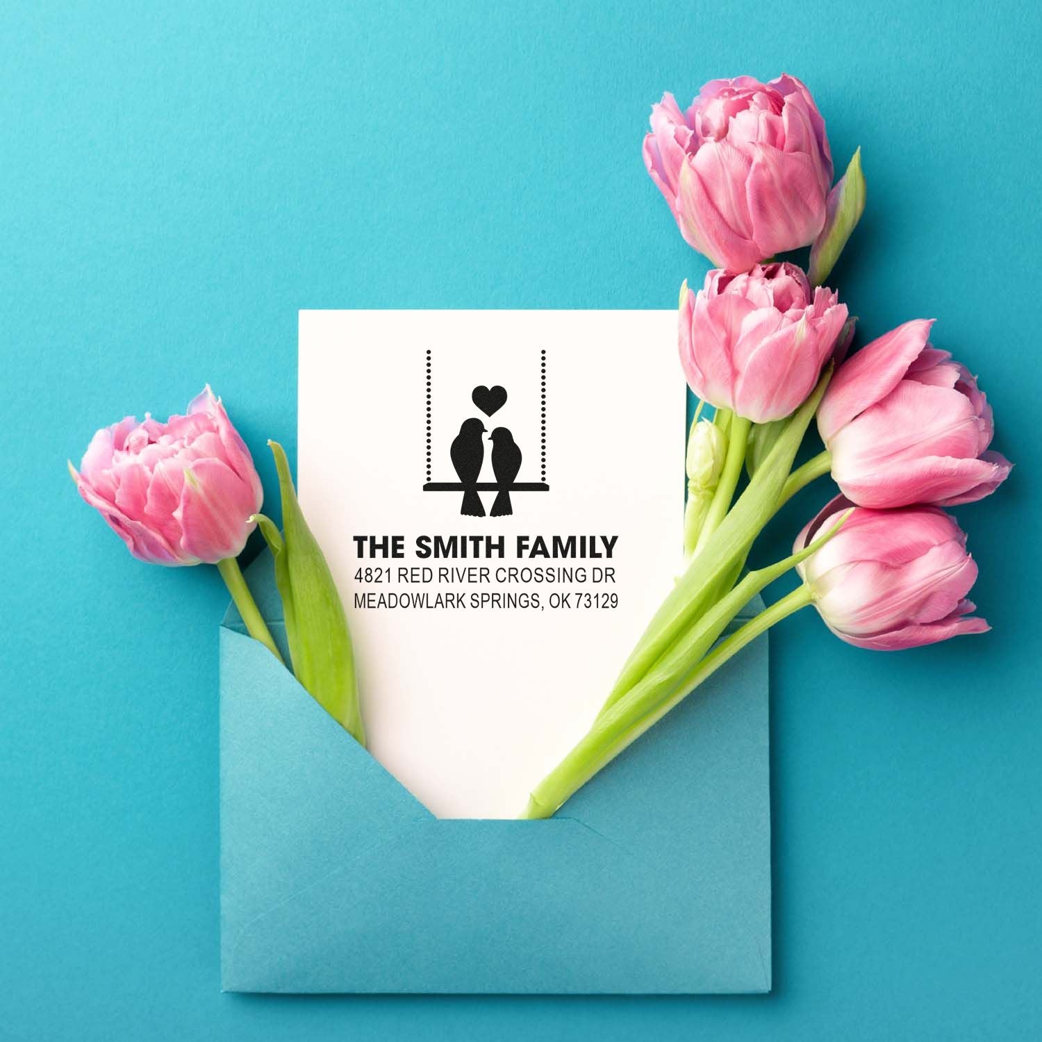 Personalized return address rubber stamp with bird and heart design, featuring The Smith Family name and address on a floral stationery mockup