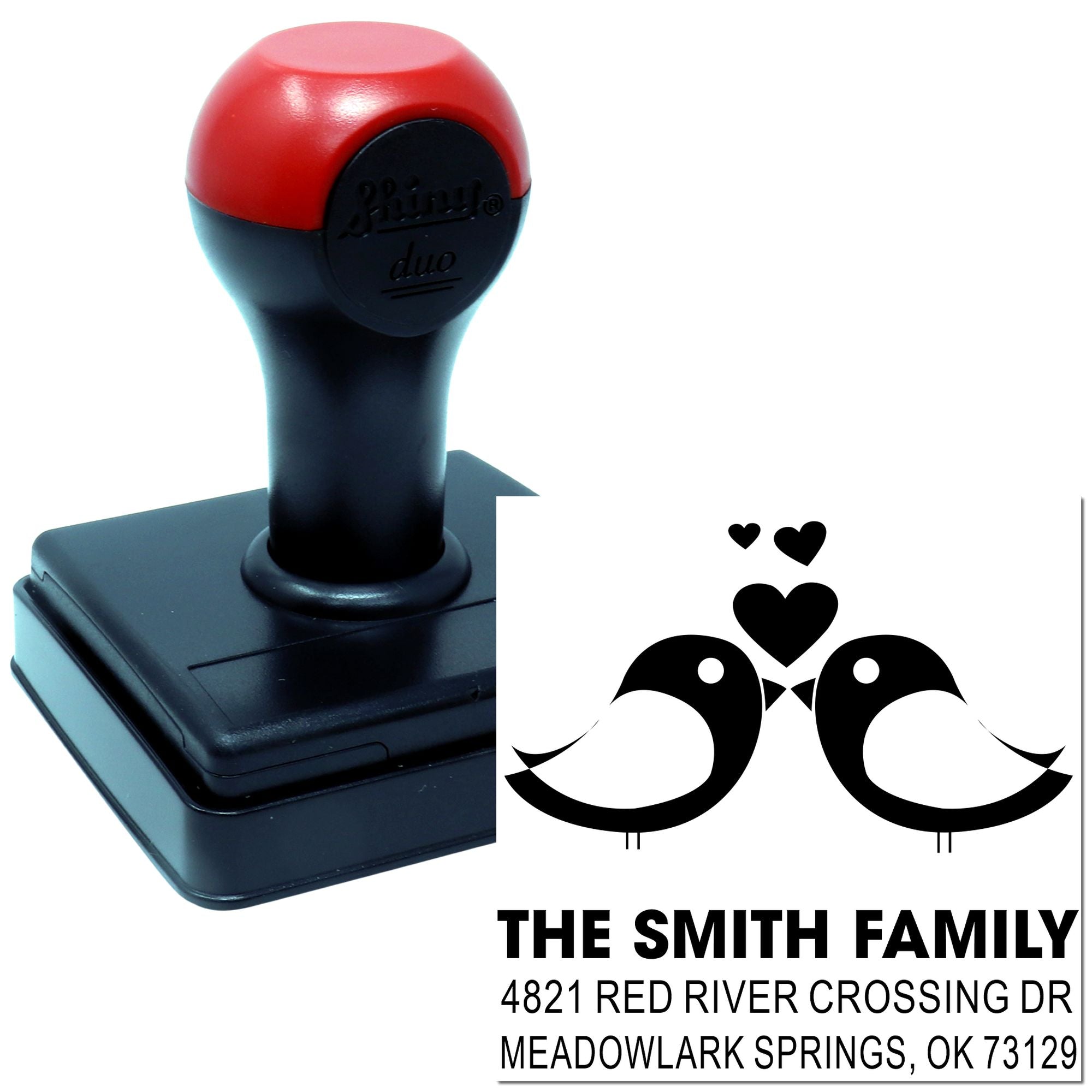 Custom self-inking rubber stamp with red and black handle, featuring twin birds and family return address design for personalized mail.