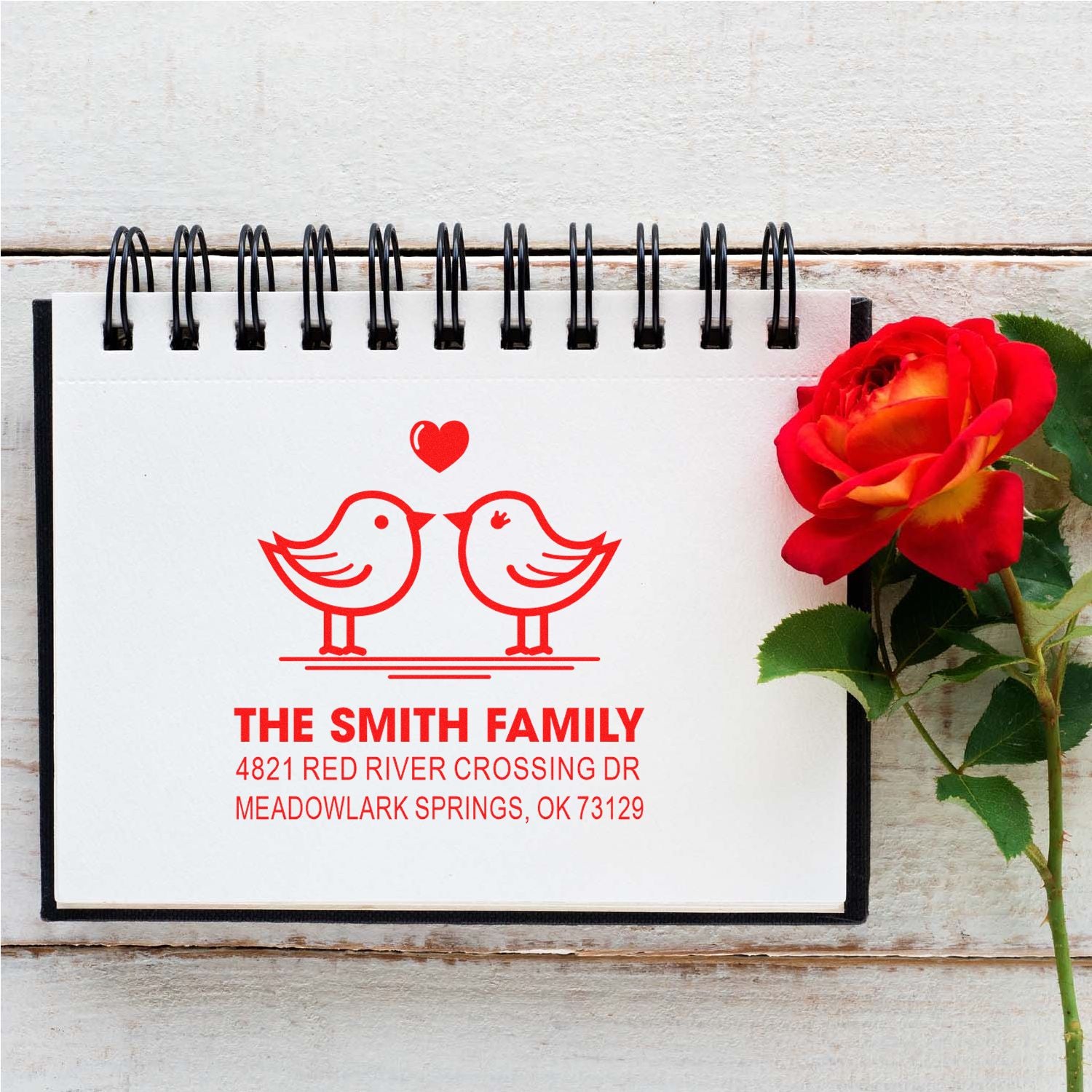 Custom self-inking address stamp with two lovebirds and heart, personalized family name and mailing address for wedding or holiday correspondence.