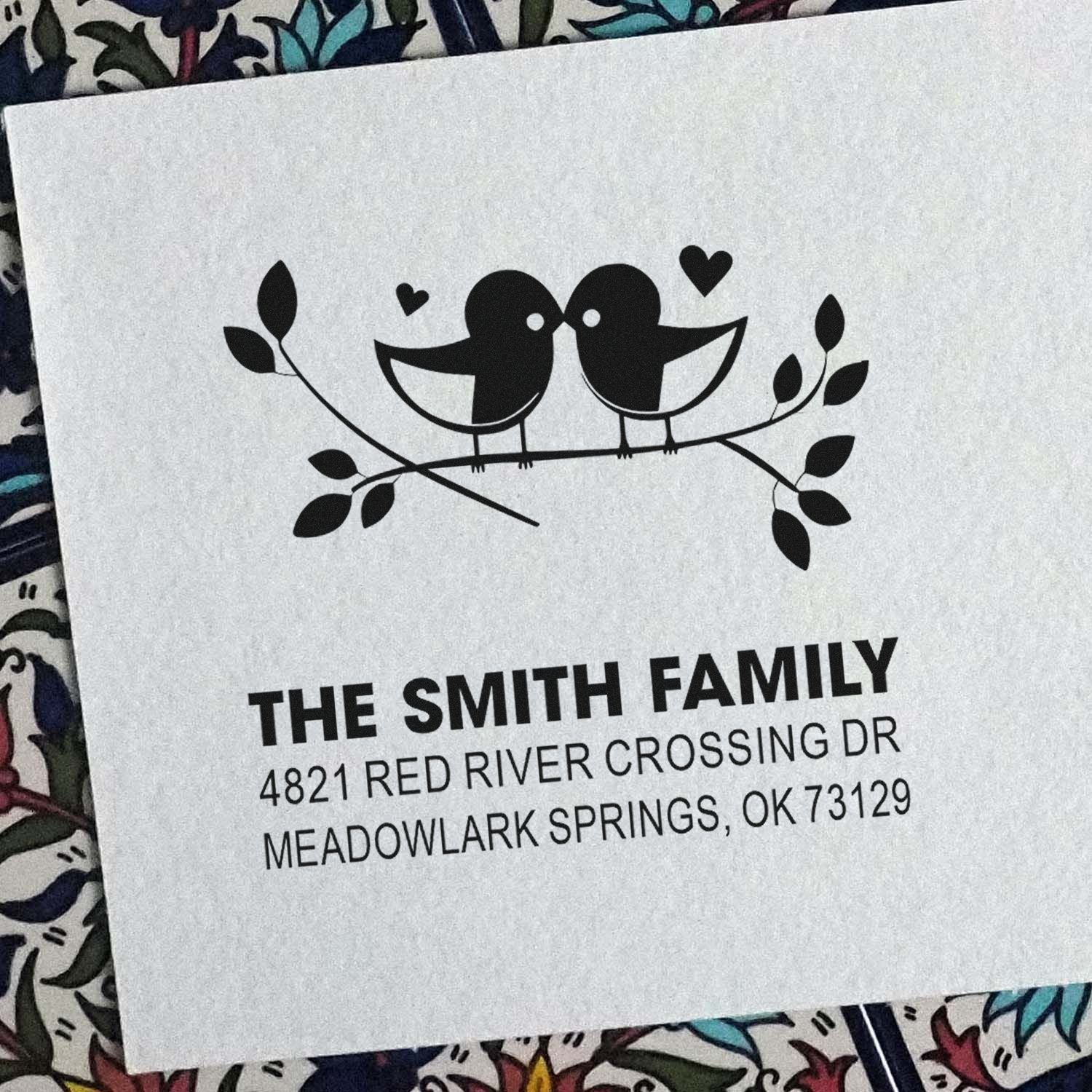 Custom family return address rubber stamp with two birds on a branch, hearts and leaves, featuring The Smith Family and Meadowlark Springs, OK 73129.
