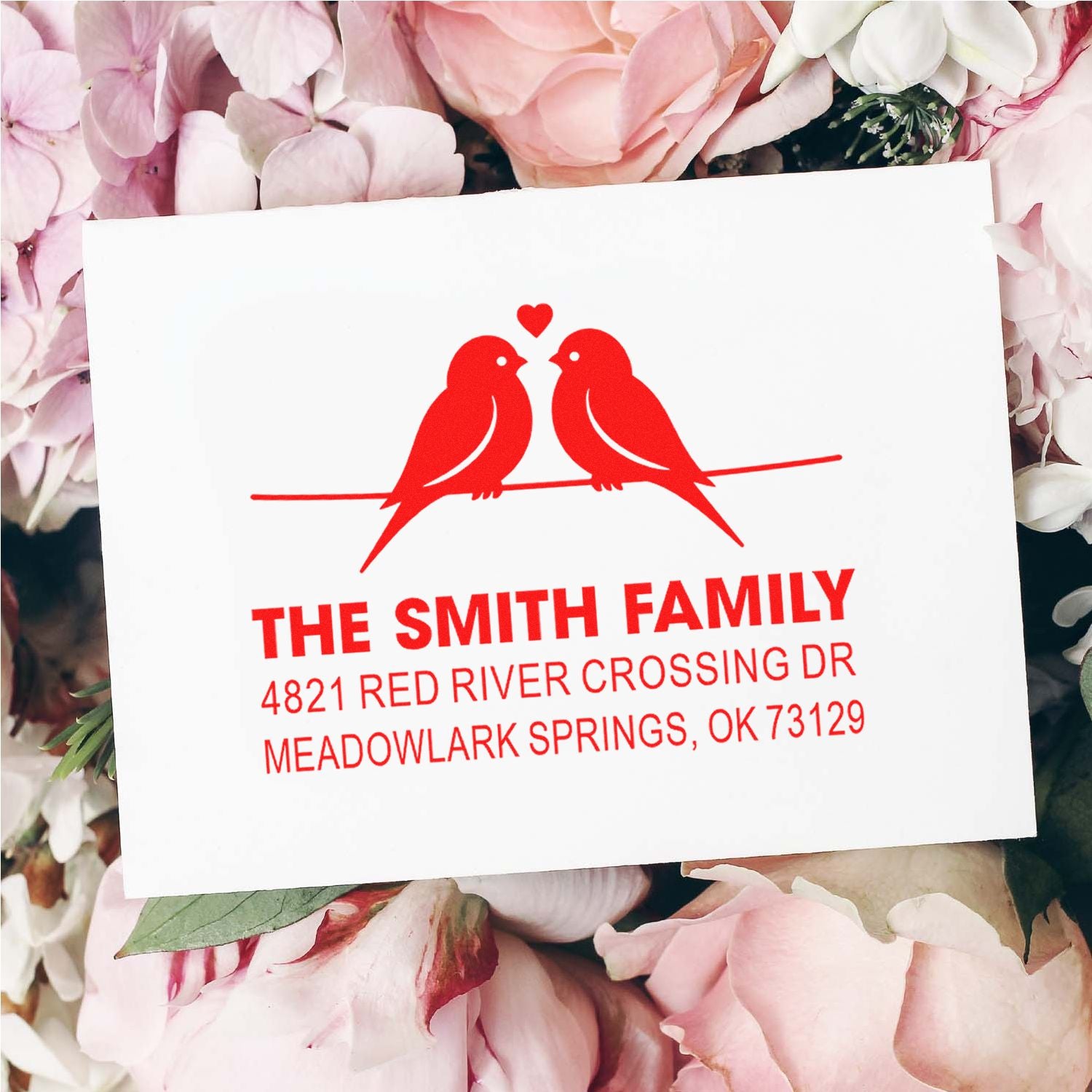 Custom return address rubber stamp with love birds and heart design, personalized family name and address for wedding or home stationery use.
