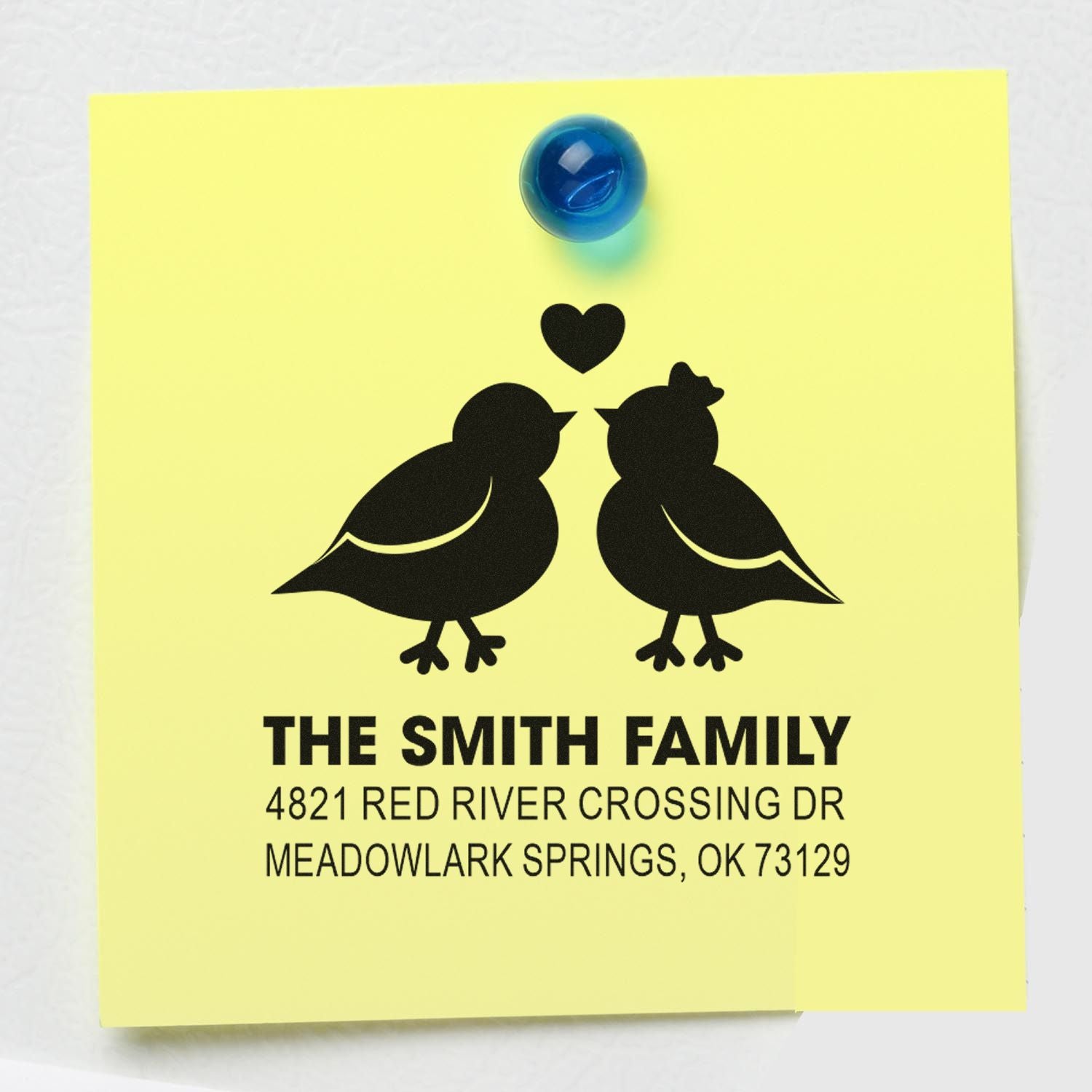 Custom family address rubber stamp with two birds and heart design for The Smith Family, featuring personalized return address on yellow note.