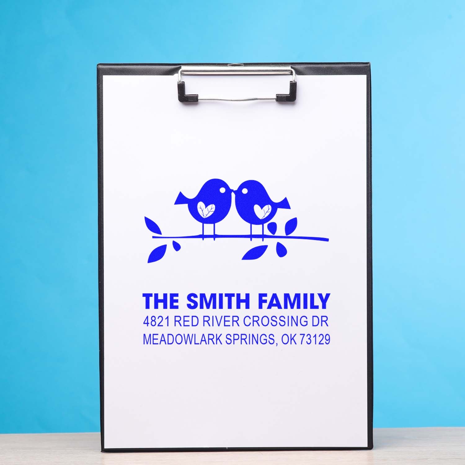 Custom family address stamp with blue bird design, personalized return address, and elegant logo for mailings, envelopes, and stationery.