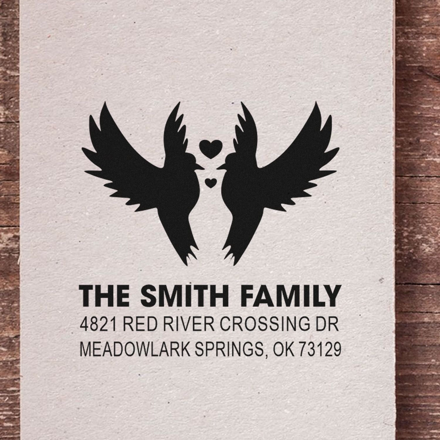 Custom rubber address stamp featuring two birds with hearts, The Smith Family name, and return address for elegant home mail and wedding invitations.