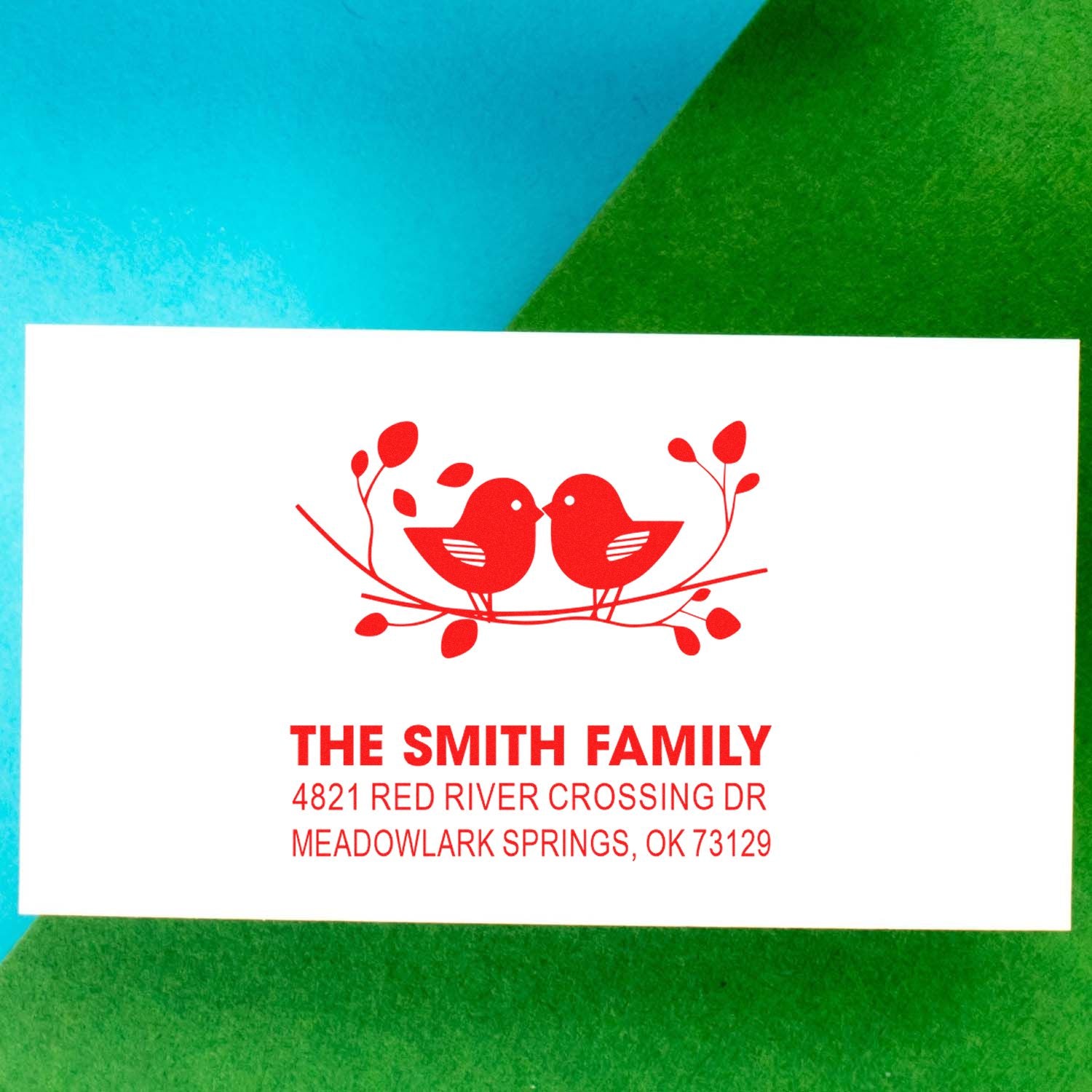 Custom return address rubber stamp with two red birds on a branch, Smith family name, and Meadowlark Springs, OK address for envelopes.