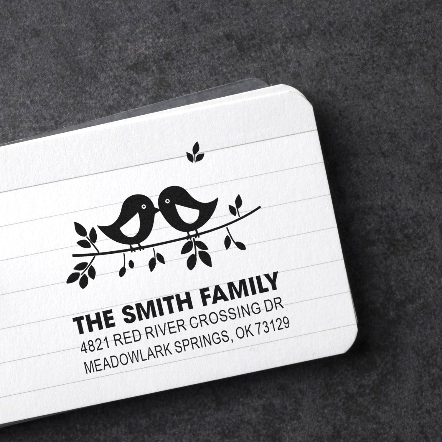 Custom return address rubber stamp with two birds on a branch, personalized family name and mailing address for envelopes and stationery.