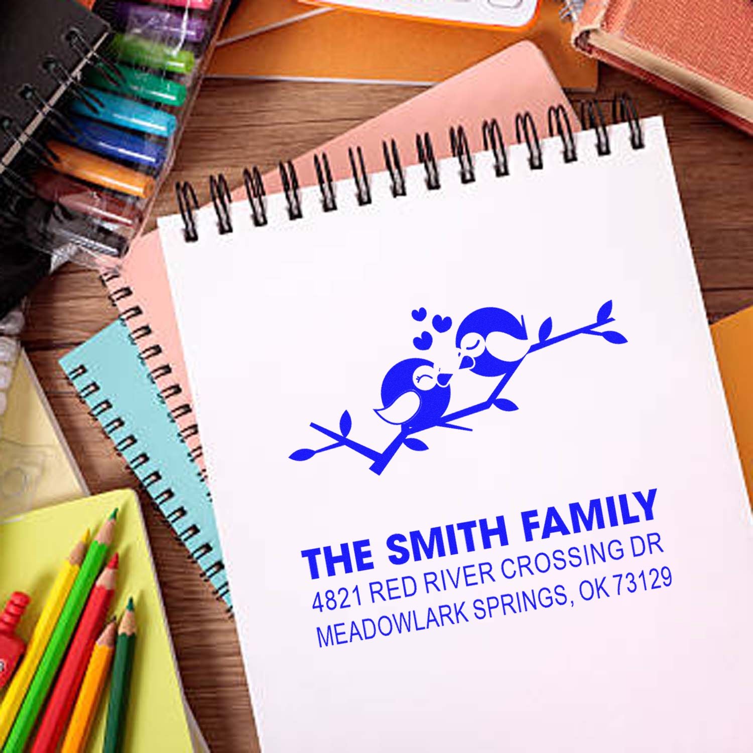 Custom self-inking rubber address stamp featuring birds on a branch, personalized family name and mailing address for cards and stationery.
