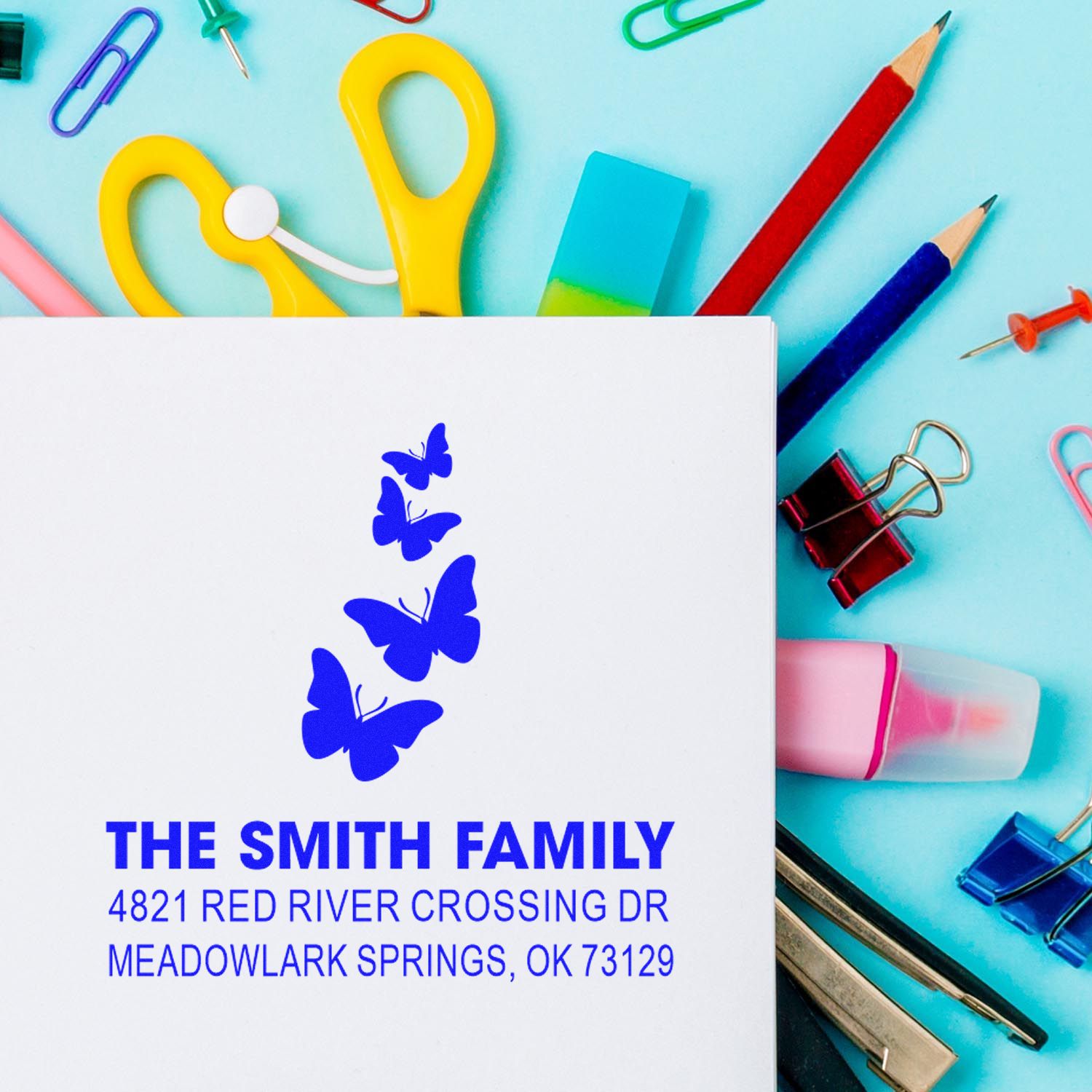 Custom return address rubber stamp with butterfly design, personalized The Smith Family name, and address for Meadowlark Springs, OK 73129.
