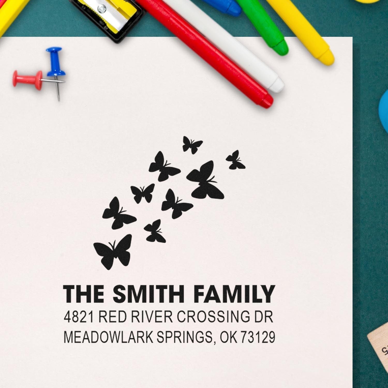 Custom butterfly address rubber stamp for The Smith Family, featuring flying butterflies and personalized return address for envelopes and mail.