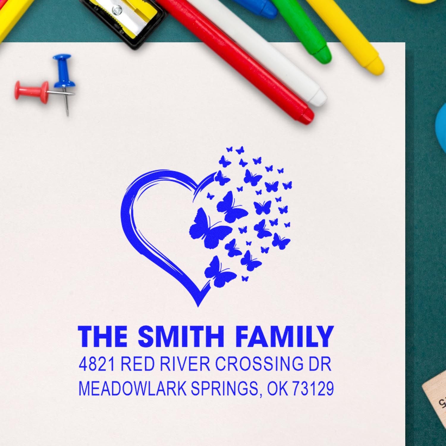 Custom return address rubber stamp with heart and butterfly design, personalized for The Smith Family, Red River Crossing Dr, blue ink for home mailings