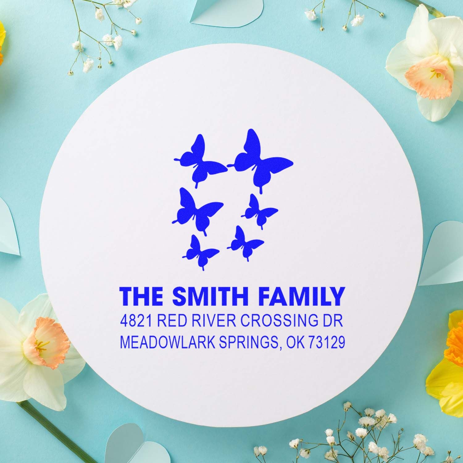 Custom butterfly family address rubber stamp with The Smith Family name and Meadowlark Springs, OK mailing address in bold blue ink