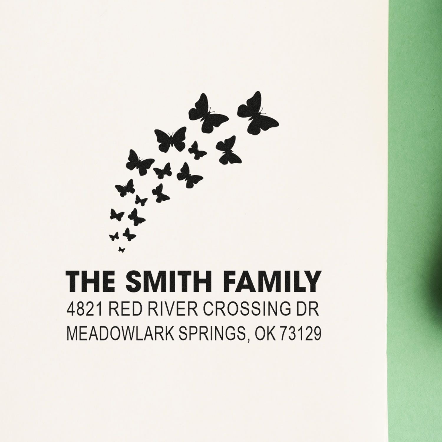 Custom butterfly return address rubber stamp for The Smith Family, featuring a modern design with name, street address, and Meadowlark Springs, OK 73129