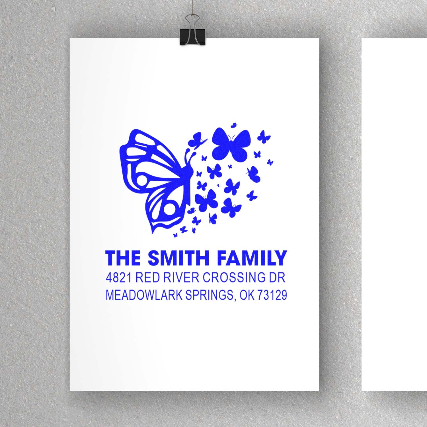 Custom butterfly family address rubber stamp with The Smith Family return address, Meadowlark Springs, OK, and decorative blue butterfly design.