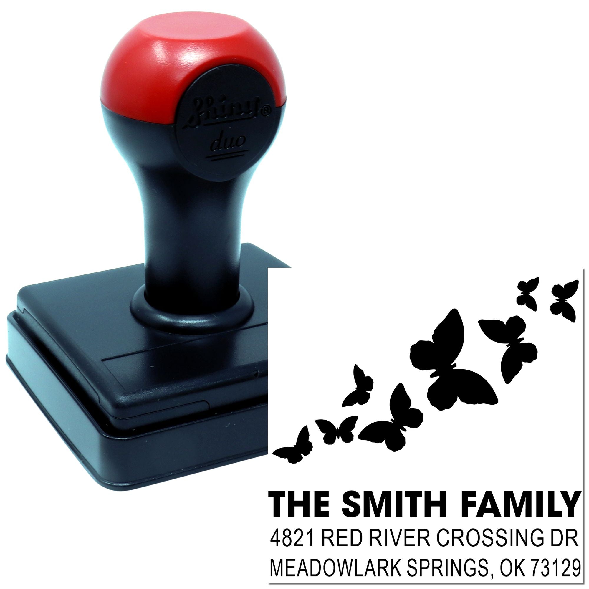 Custom self-inking rubber return address stamp with butterfly design, family name imprint, and durable red and black handle for mailings.