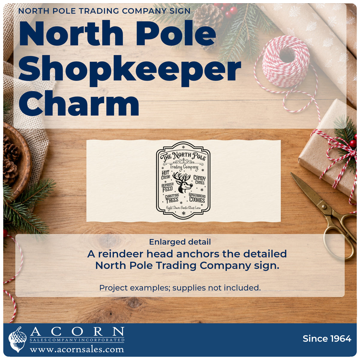 Enlarged detail of the North Pole Trading Company Sign Candy Cane Craft Stamp – Self-Inking imprint. A bordered North Pole Trading Company sign features a reindeer head surrounded by hot cocoa, candy canes, reindeer feed, trees, and cookie wording.