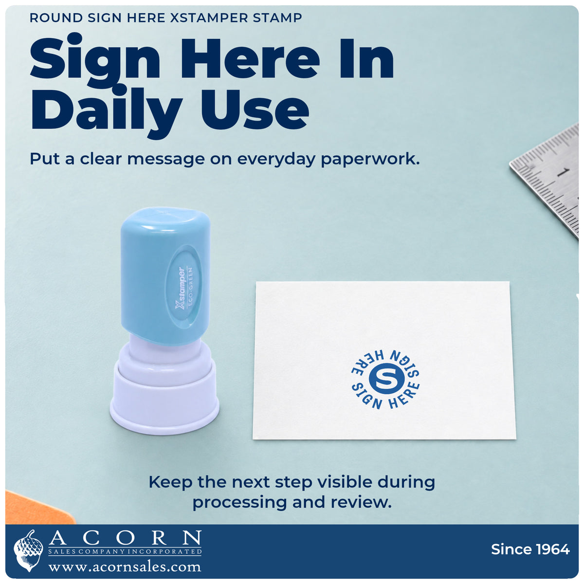 Xstamper Sign Here Stamp – Round Blue Pre-Inked being pressed to leave an imprint reading "Sign here"