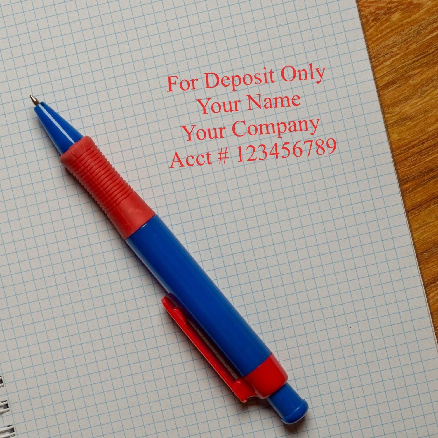 Blue and red pen on a check with For Deposit Only endorsement and account number printed in red text.