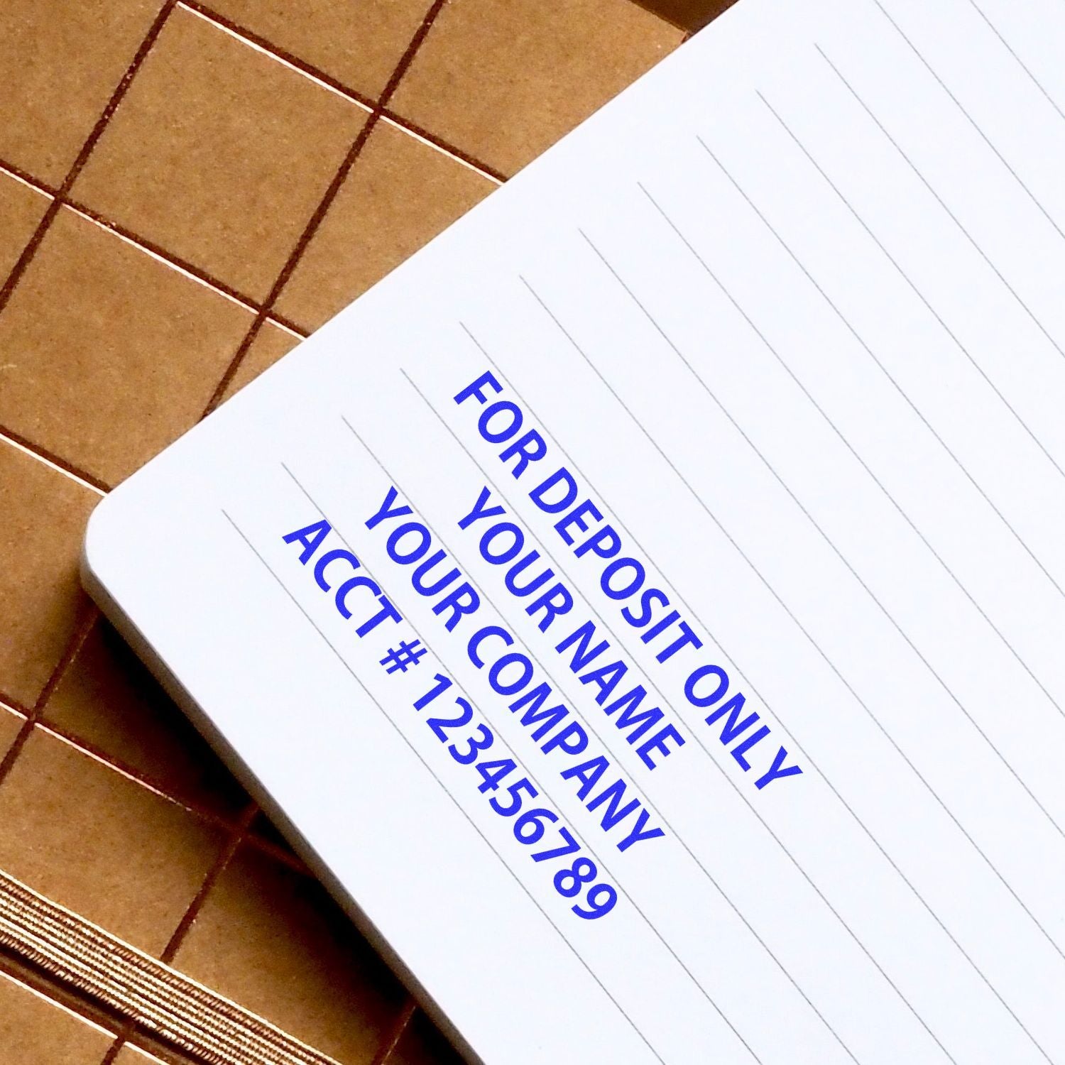 Close-up of a business bank deposit slip template with For Deposit Only and account number on lined notebook paper.