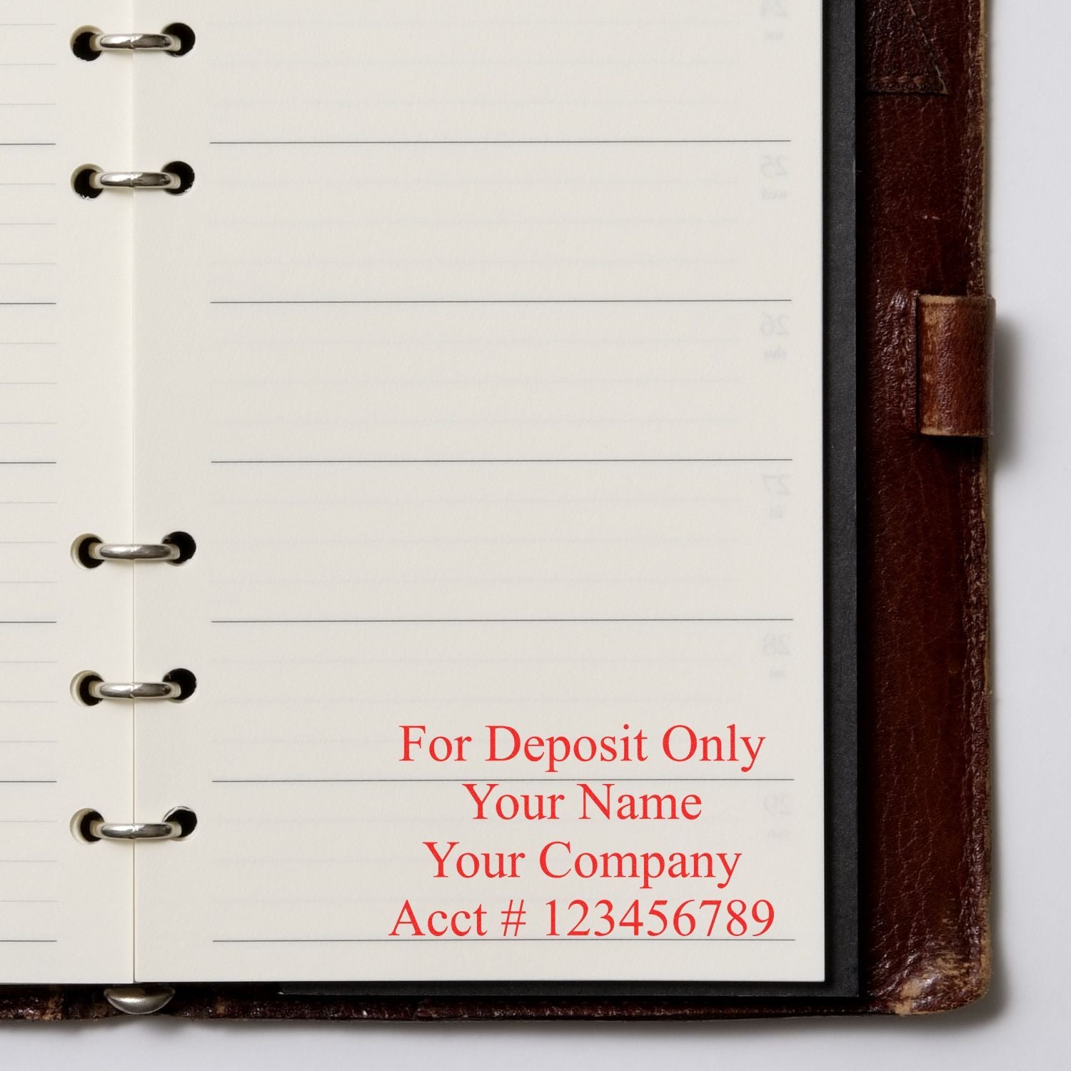 Close-up of a ring-bound checkbook deposit slip template with For Deposit Only business banking details and account number placeholder.