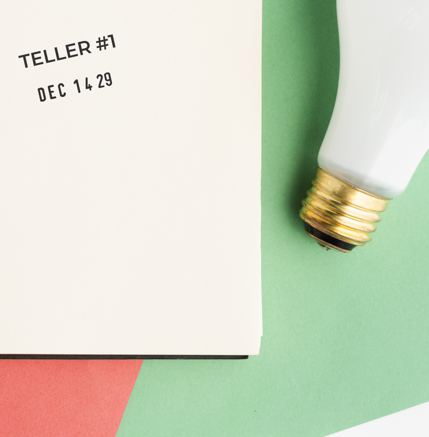 Close-up flat lay of a vintage light bulb beside a stamped teller form with Teller #1 and date Dec 14 29 on a green and red background.