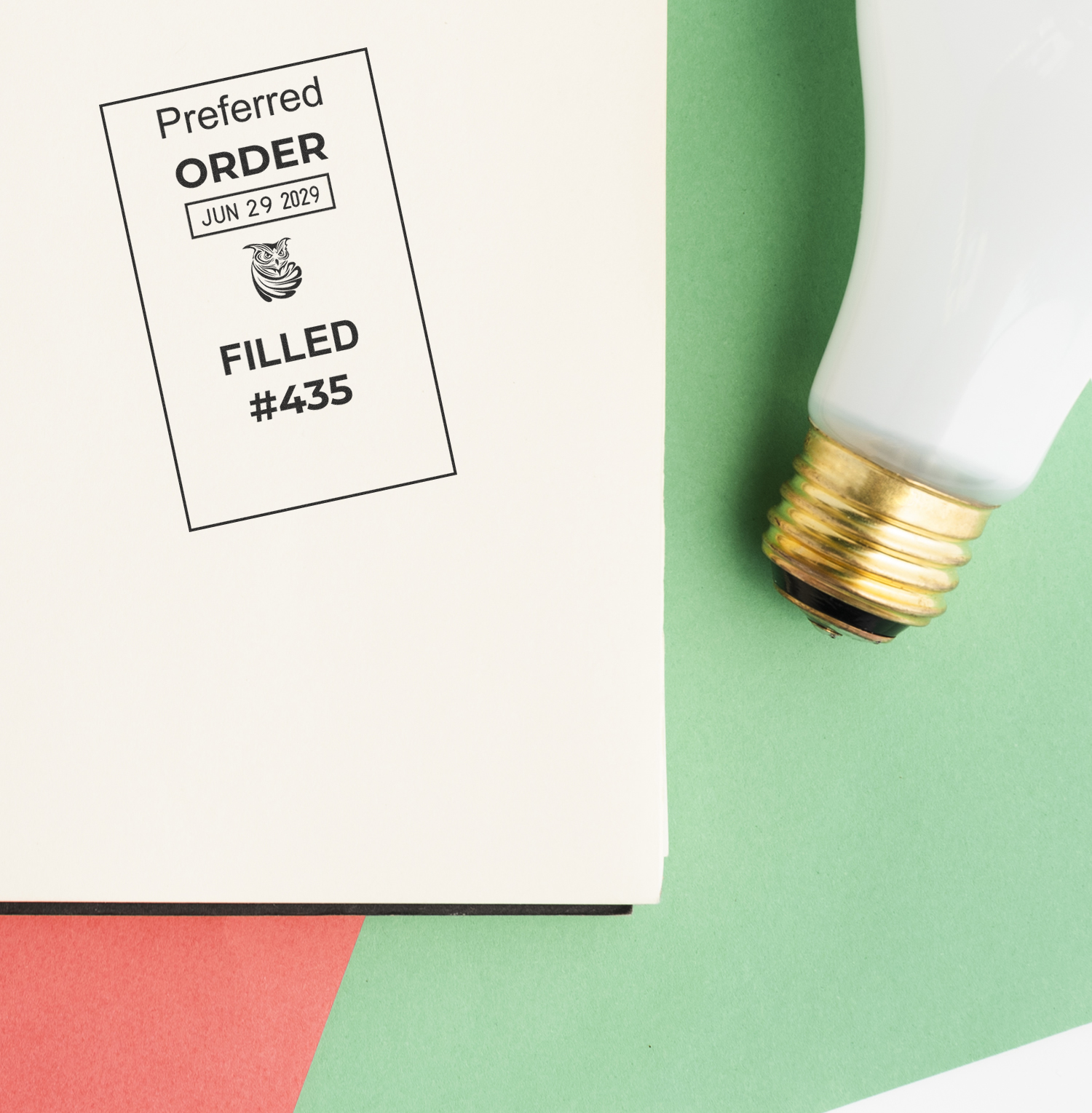 Preferred order filled stamp on a document beside a light bulb on a green and white background.