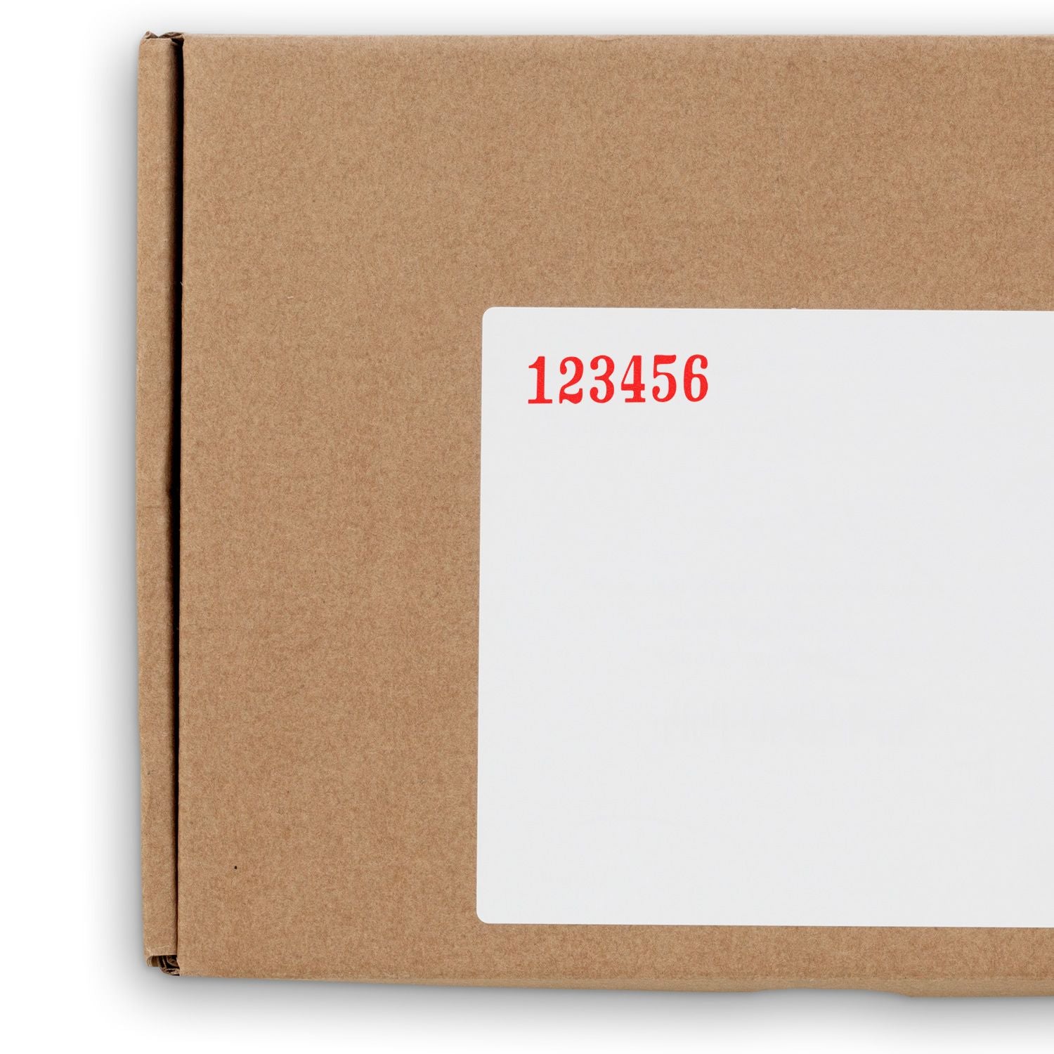 Close-up of a brown cardboard shipping box with a white label and red number 123456