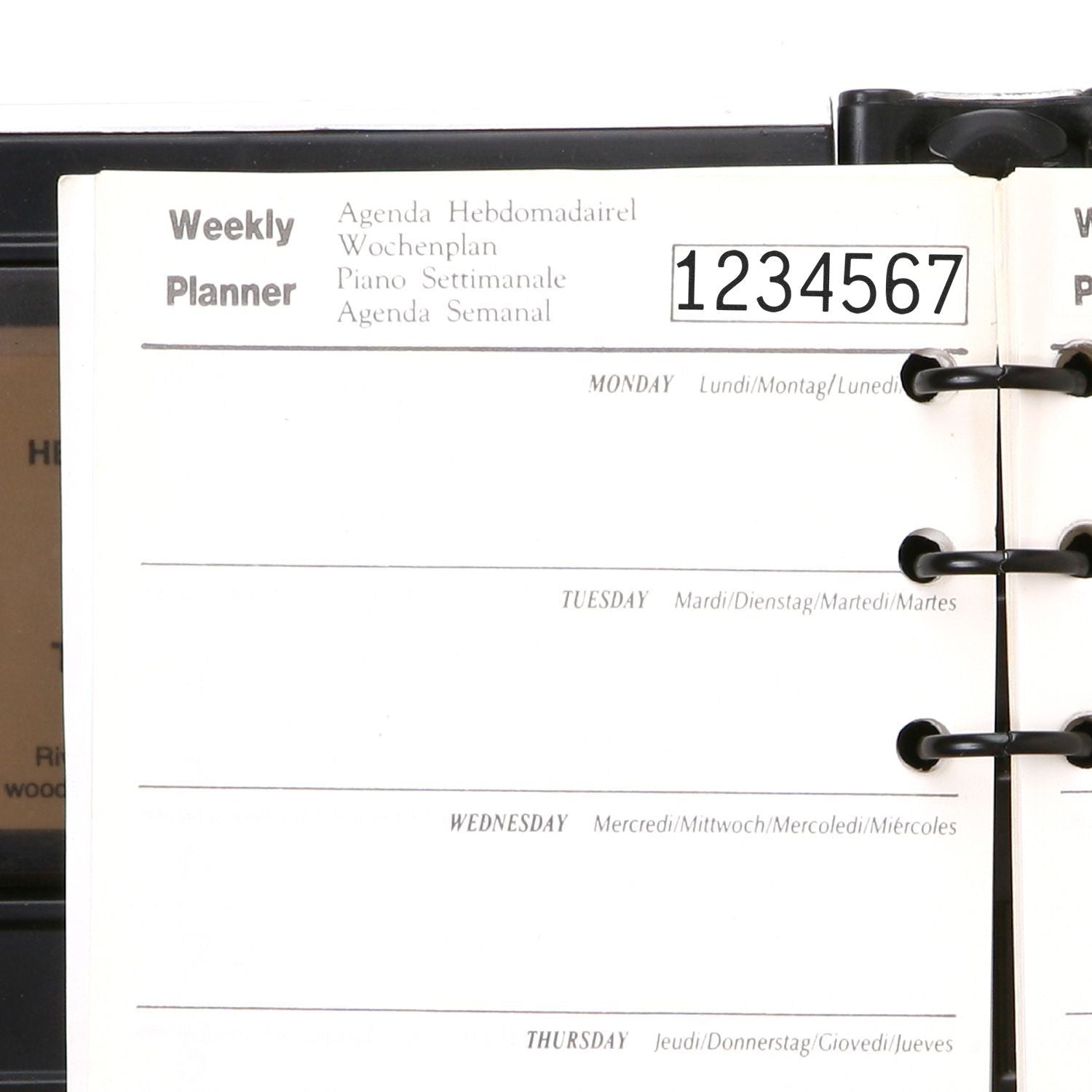 Multilingual weekly planner page in a ring-bound organizer with weekday sections and numbered tabs.