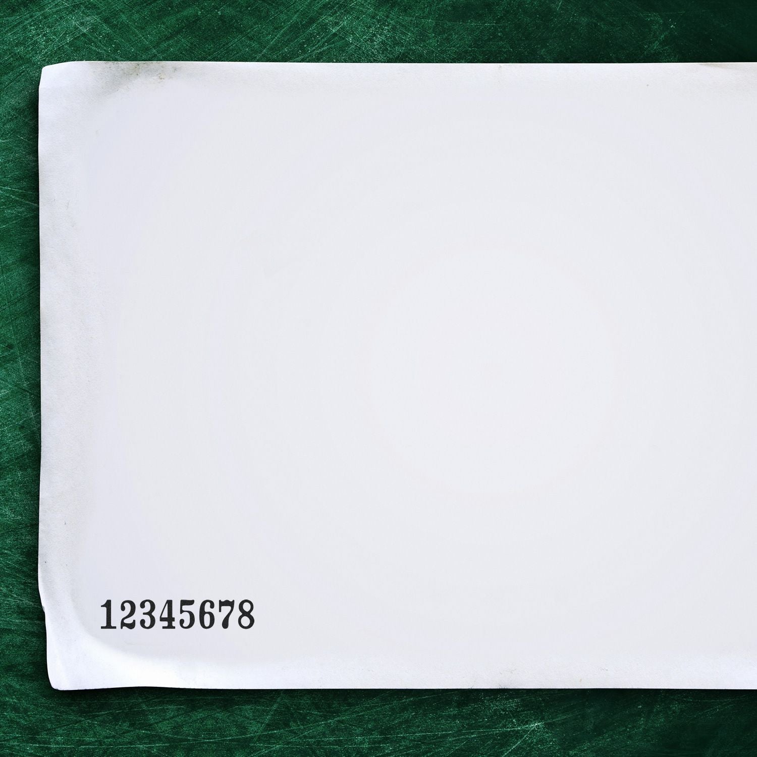 Blank white paper sheet on green textured background with printed number 12345678 in the corner.