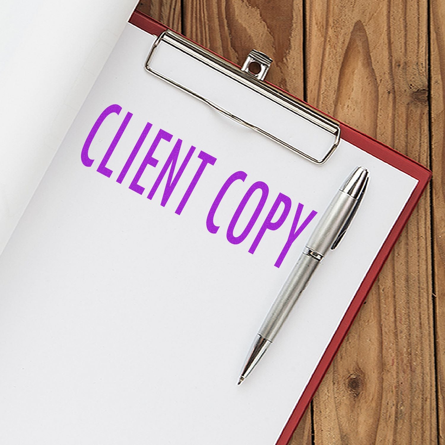 Client copy document with binder clip and pen on desk, branding-focused office supply image for client invoices.
