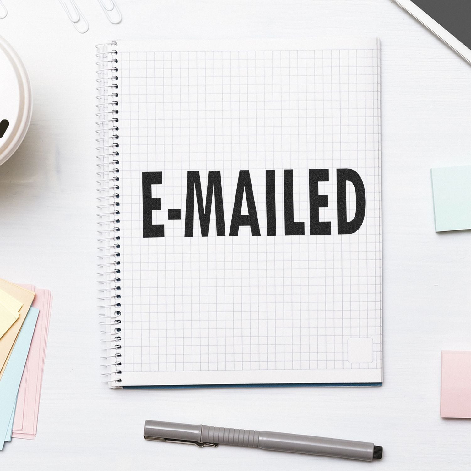 Open notebook with bold EMAIL word on grid paper, symbolizing email communication and marketing.